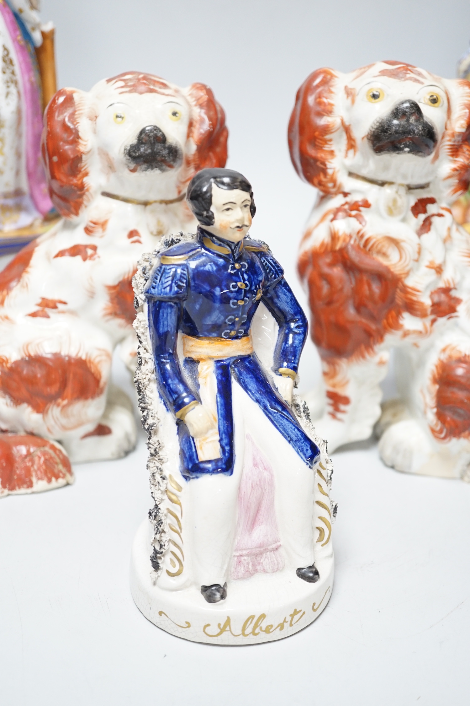 A pair of late 19th century French porcelain figures of cavalier and a maiden, a late pottery figure of Prince Albert and a pair of Staffordshire dogs (5)